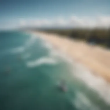 An aerial view of a pristine beach with kiteboarders and powered surf foils in action.