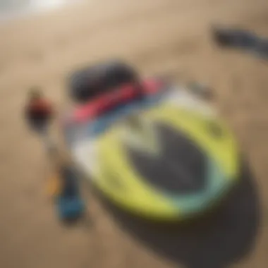 Close-up of essential kite surfing equipment laid out on the beach