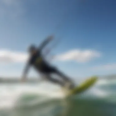 Kiteboarders riding the waves at Tigertail Beach under a clear blue sky.