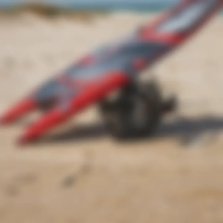 Close-up of specialized wing sailing gear laid out on the beach