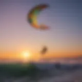 Kite surfer gliding over waves at sunset