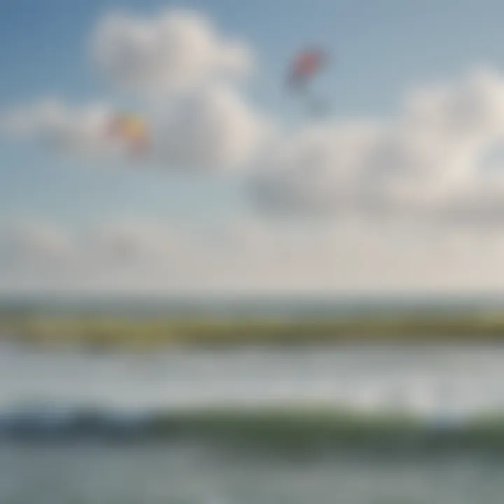 Wide view of a popular kiteboarding spot with clear skies and vibrant kites