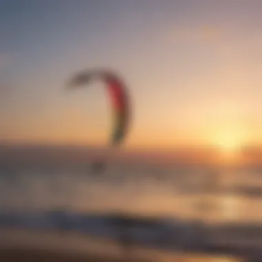 A serene sunset over the water with kiteboards resting on the shore