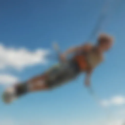 Kiteboarder soaring through the air with a vibrant kite against a clear blue sky